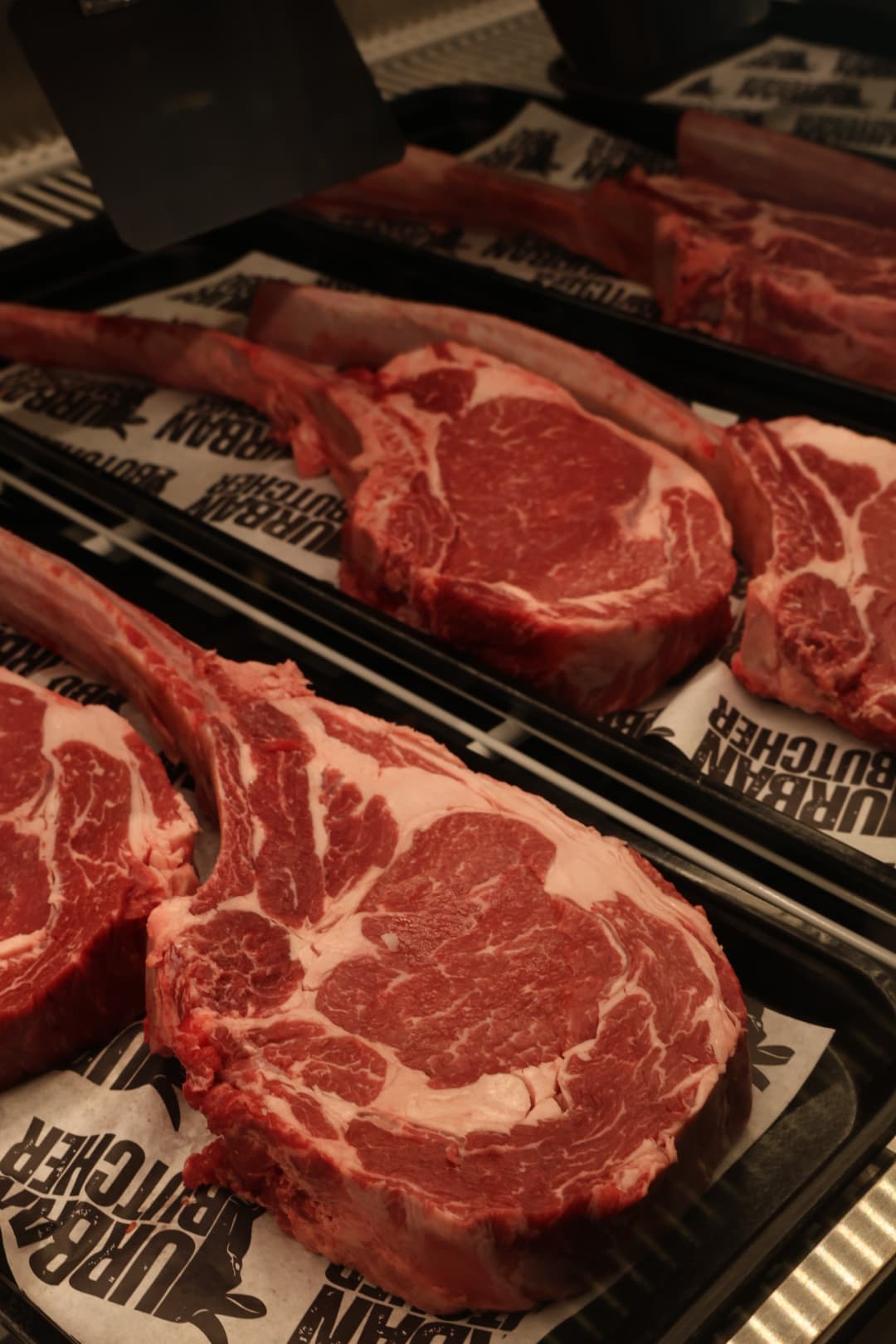 Tomahawk and bone-in steaks in the Urban Butcher case